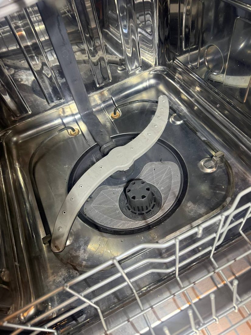 Spray arm and filter area inside a built-in kitchen unit during a Bremerton service visit
